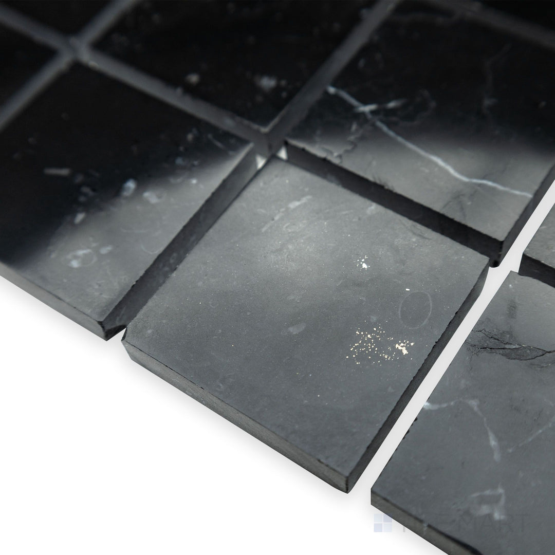 A structured and polished aesthetic is emphasized in this corner view of Negro Marquina Marble 2" square polished mosaic, where its sleek surface enhances the refined grid pattern.