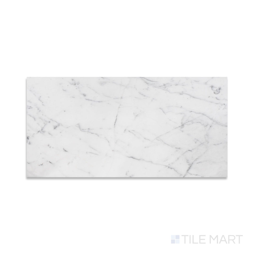 A fine-textured look at Statuary White Marble 12X24 Honed, showcasing a soft white surface with graceful gray veining.