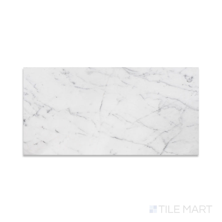 A fine-textured look at Statuary White Marble 12X24 Honed, showcasing a soft white surface with graceful gray veining.