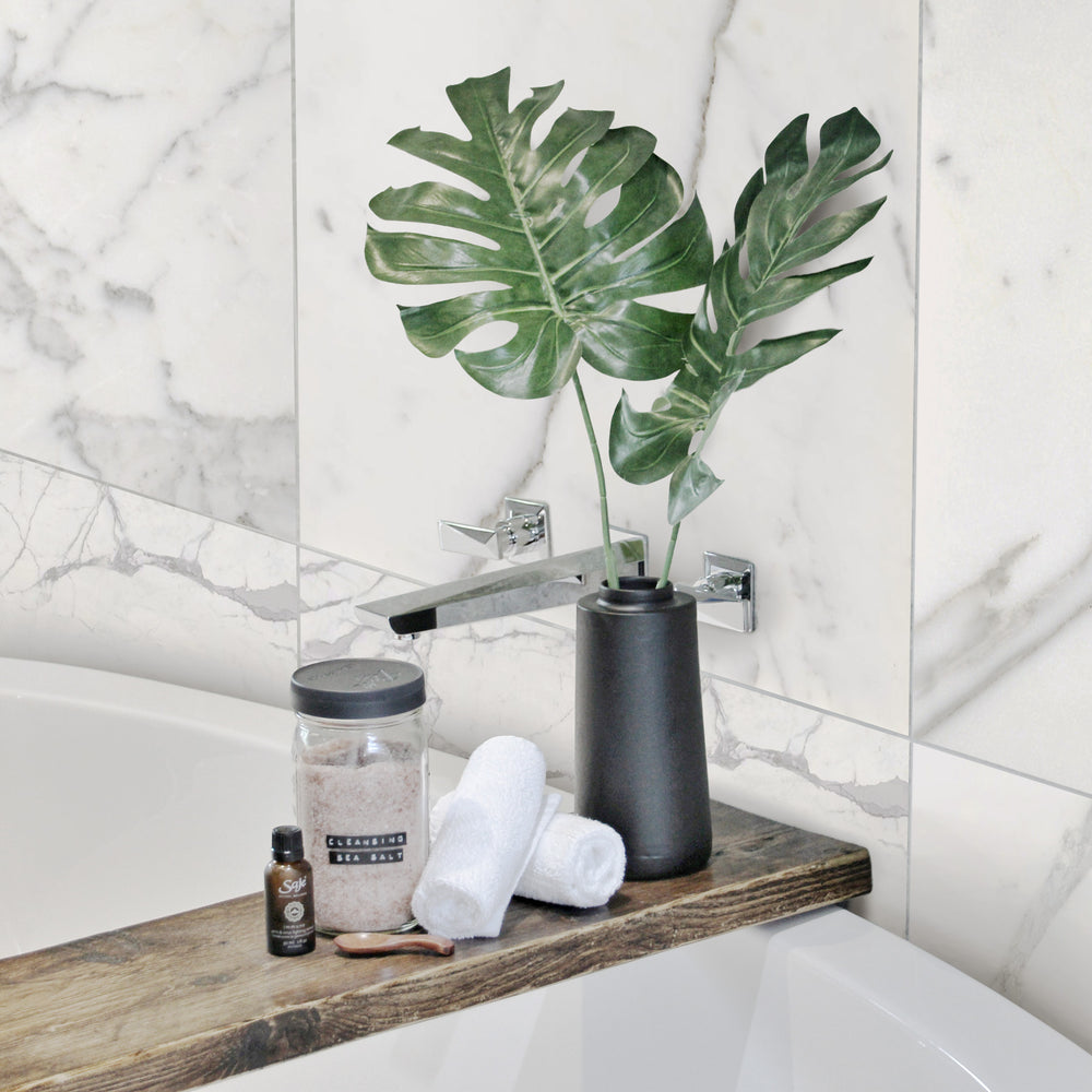 A light-filled and elegant space designed with Statuary White Marble 12X24 Honed, showcasing its subtle gray veining and honed texture for a sophisticated, classic look.