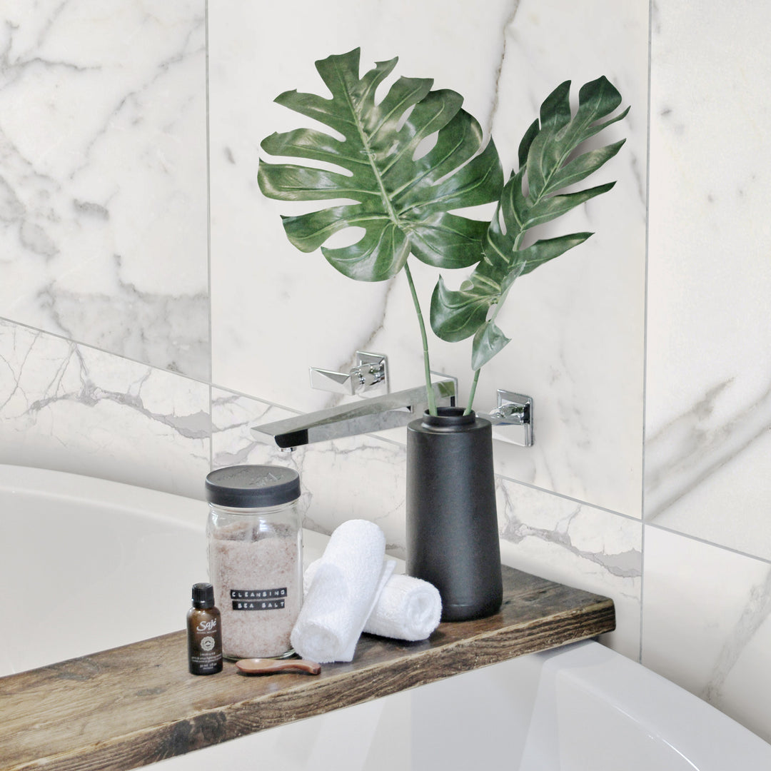 A light-filled and elegant space designed with Statuary White Marble 12X24 Honed, showcasing its subtle gray veining and honed texture for a sophisticated, classic look.