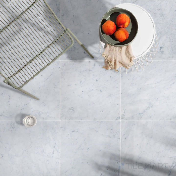 Understated luxury featuring White Carrara Marble 3X6 Honed in an elegant, light-filled space