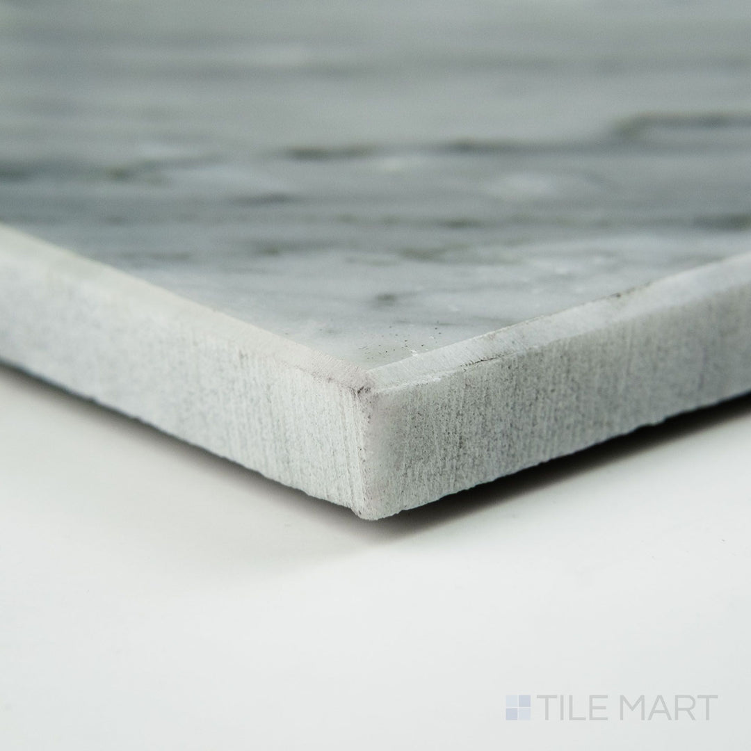 Angled view of White Carrara Marble 3x6 honed tile, showcasing soft matte surface and classic marble veining