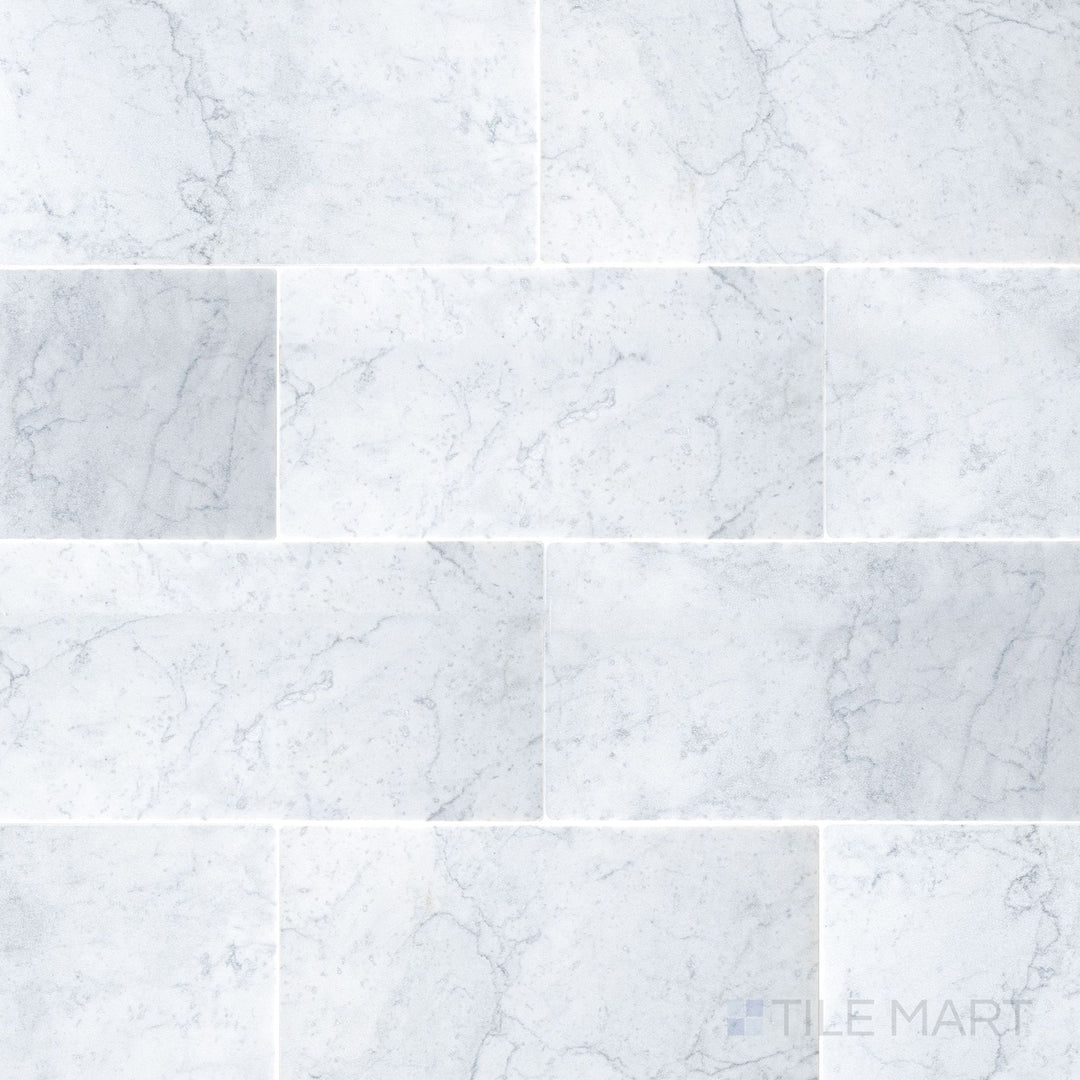 White Carrara marble 3x6 tile with a tumbled finish and soft stone texture