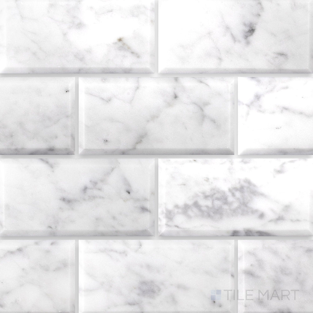Flat lay of White Carrara Marble 3x6 beveled polished tile showcasing crisp beveled edges with a bright, glossy marble surface