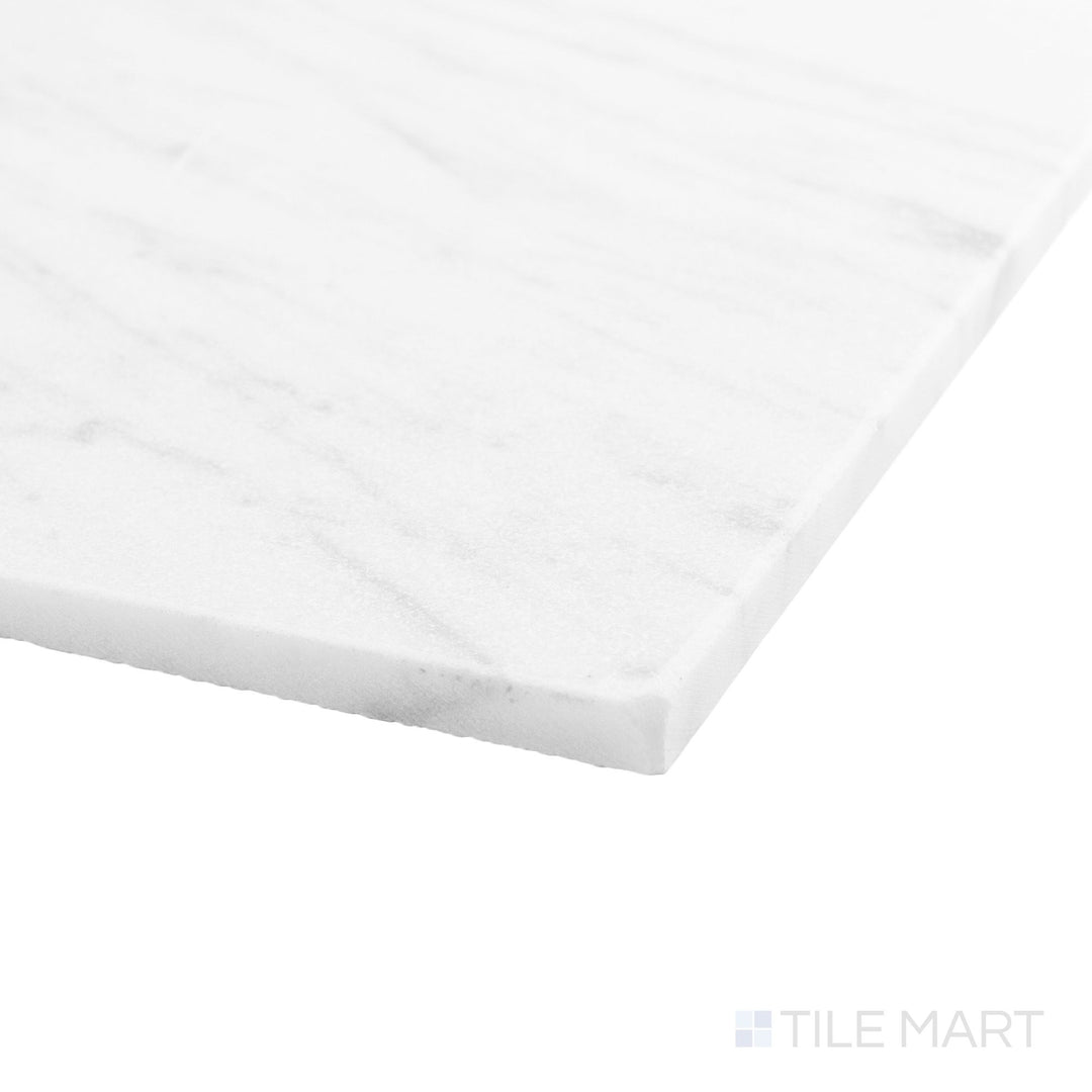 Corner angle of White Carrara marble 4x4 tile highlighting tumbled surface and natural variation