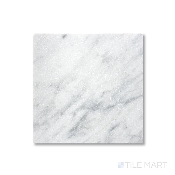 Top-down detail of White Carrara marble 6x6 tile revealing tumbled finish and subtle veining