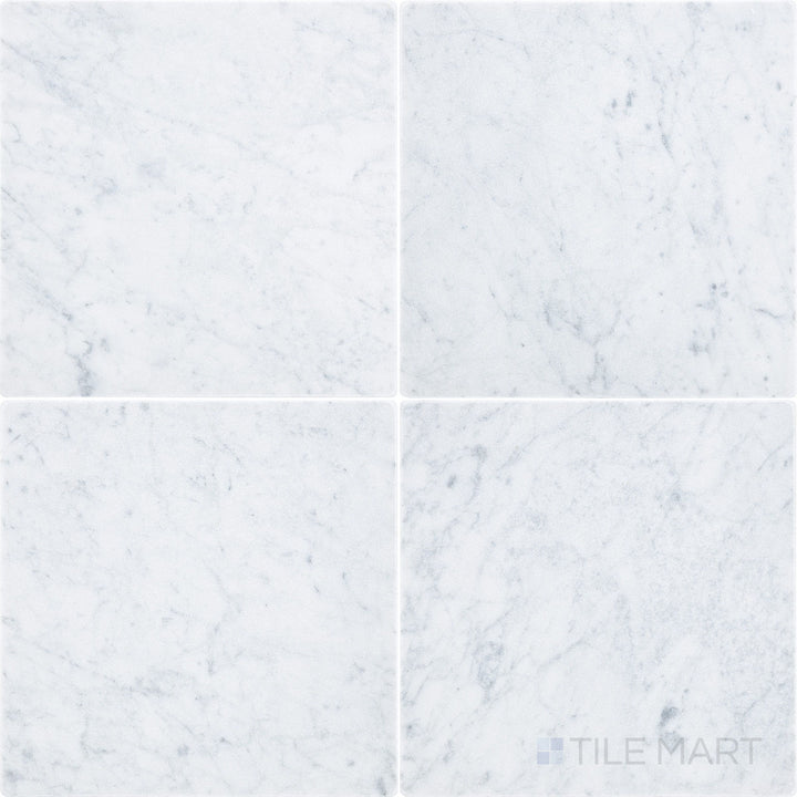 Top-down view of White Carrara Marble 12x12 tumbled tile showcasing a rustic surface with soft edges and natural marble texture