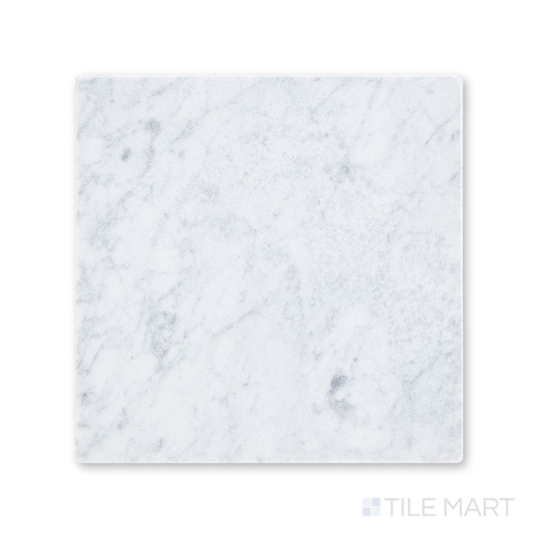 Full-piece view of tumbled White Carrara marble 12x12 tile with gentle variation and worn edges