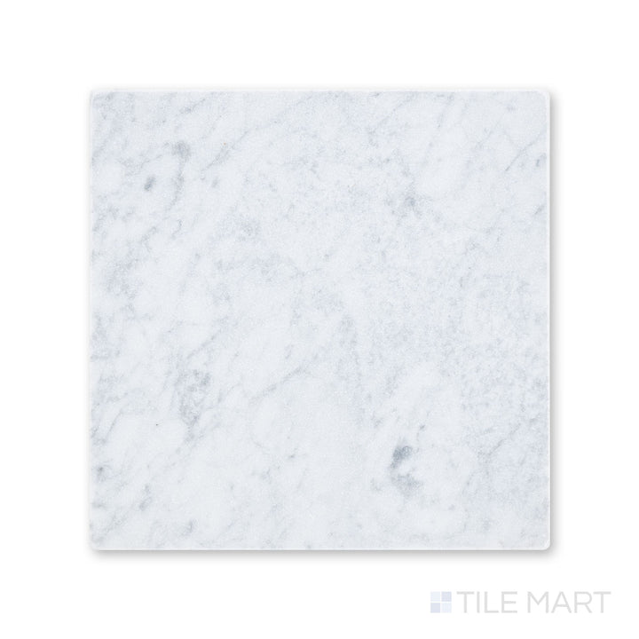 Full-piece view of tumbled White Carrara marble 12x12 tile with gentle variation and worn edges