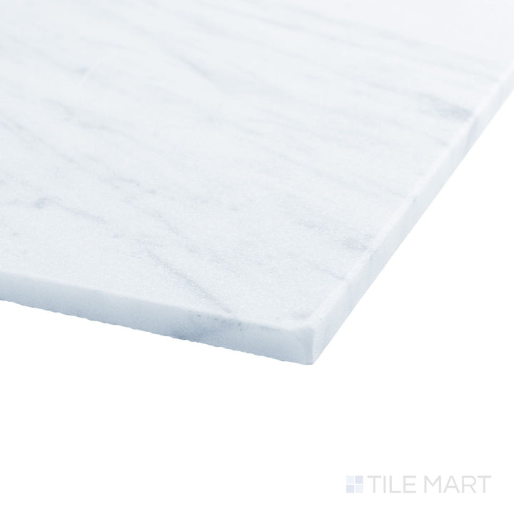 White Carrara marble 12x12 tile in corner view with tumbled finish and organic stone character