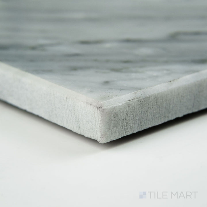 Corner perspective of White Carrara Marble 24x24 honed tile with a velvety matte texture and elegant natural gray striations
