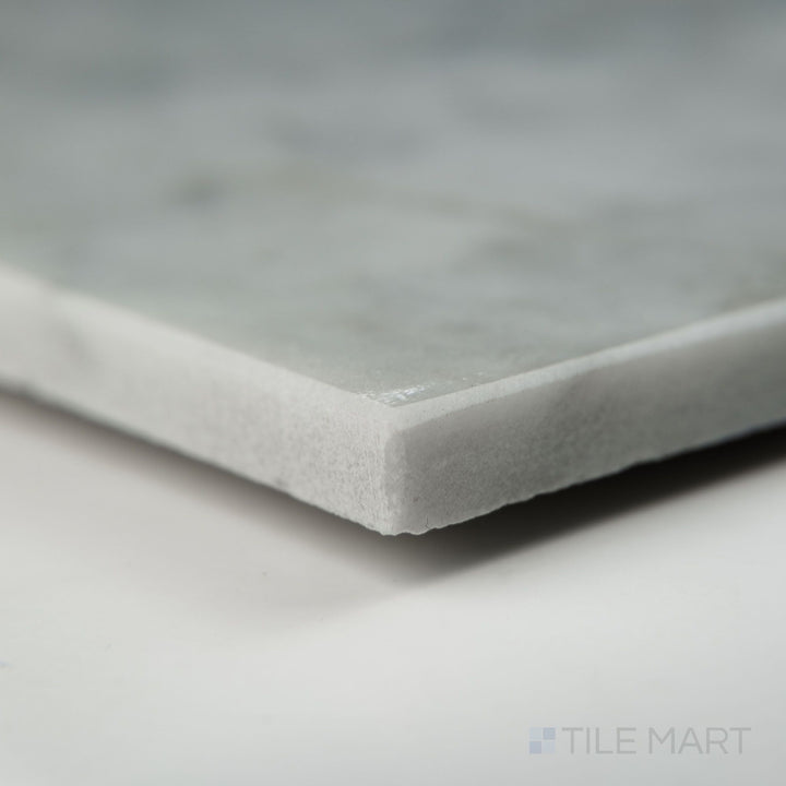 Corner view showing White Carrara Marble 24x24 polished tile with a smooth, high-gloss finish and rich marble character