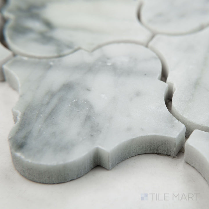 Angled view of White Carrara Marble 3" arabesque honed mosaic showing soft matte marble with elegant curved shapes