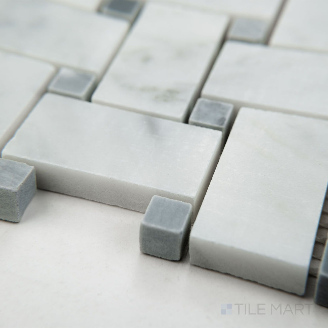 Corner shot of White Carrara Marble basketweave mosaic with blue dot in a honed finish, showcasing intricate tile pattern with soft texture and subtle color contrast.