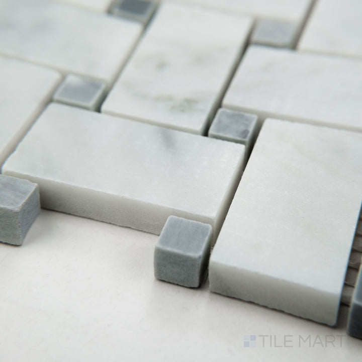 Corner shot of White Carrara Marble basketweave mosaic with blue dot in a honed finish, showcasing intricate tile pattern with soft texture and subtle color contrast.