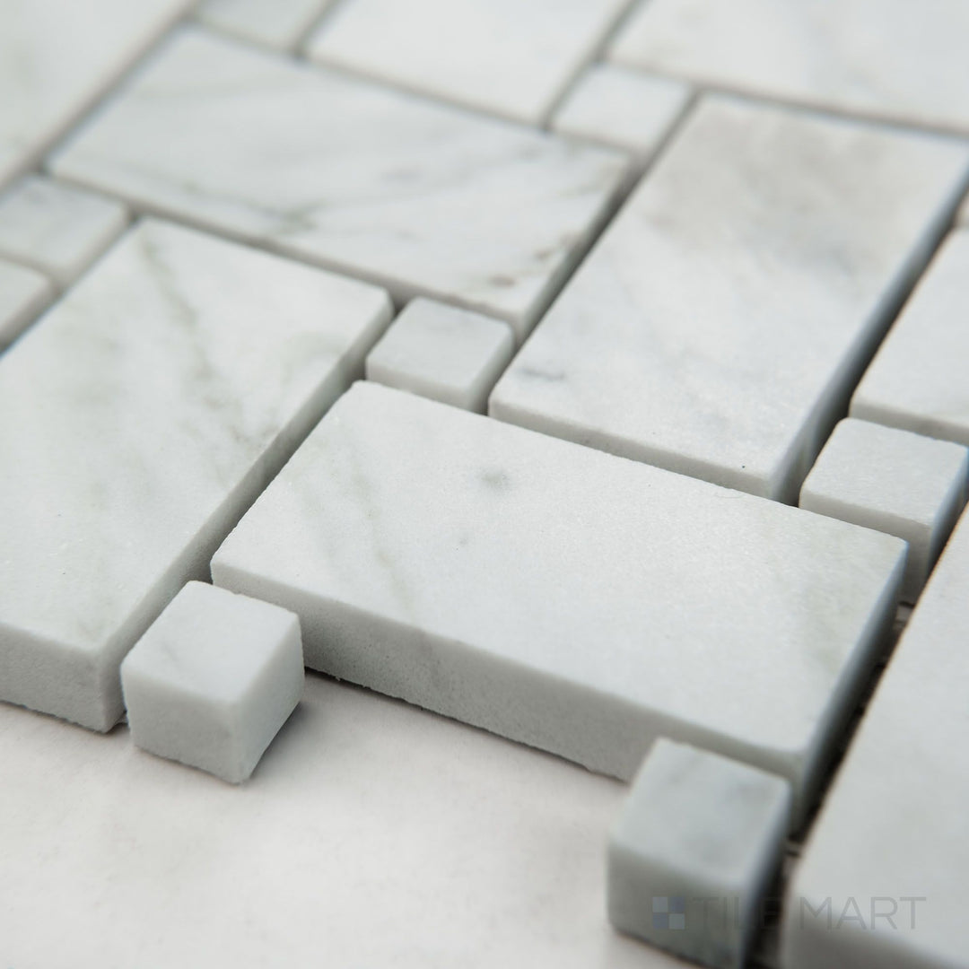 Tile corner display of White Carrara Marble basketweave with white dot honed mosaic featuring matte marble and bright accents