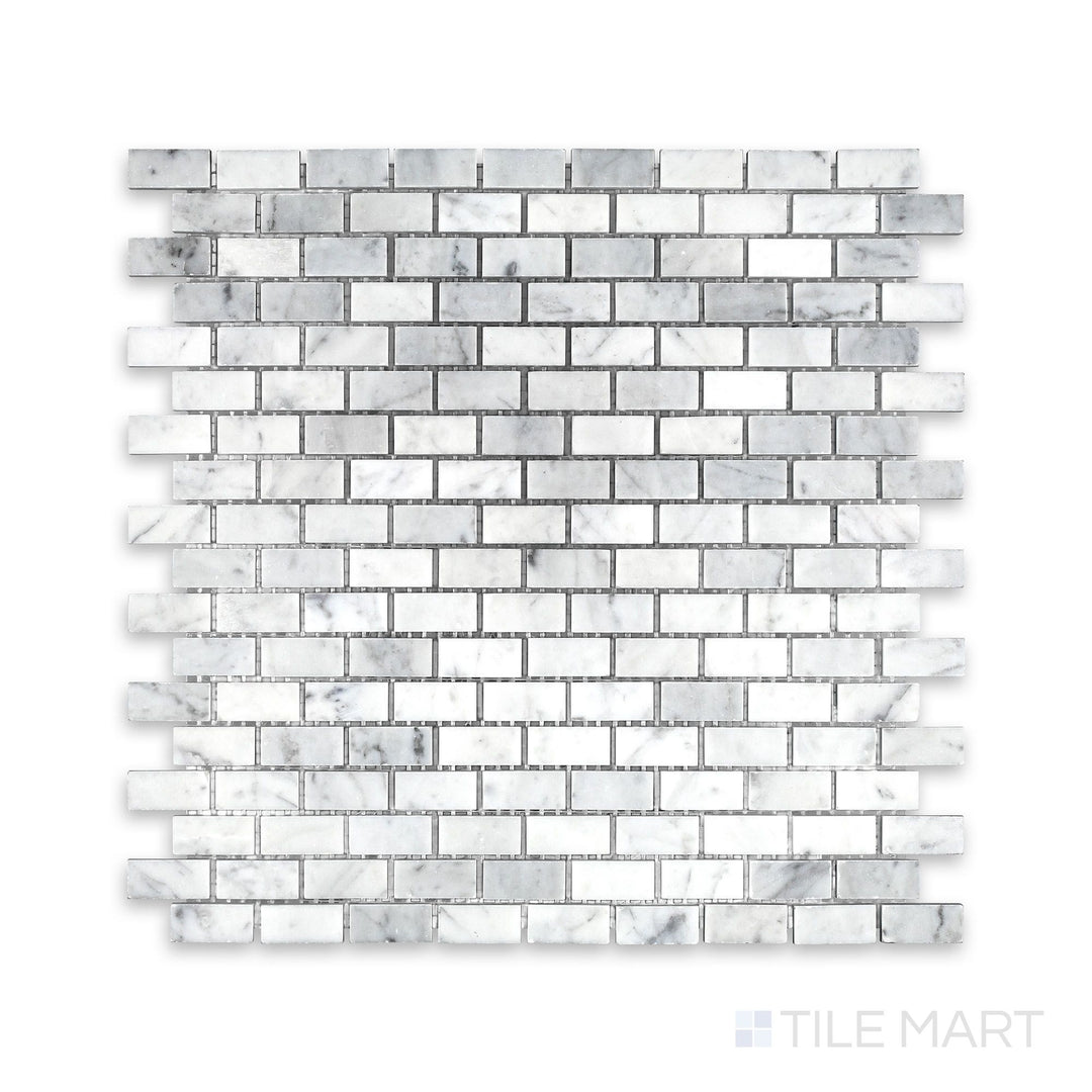 Tile arrangement of White Carrara Marble 5/8x1-1/4 brick honed mosaic showing soft-textured rectangular marble pieces in a clean brick layout
