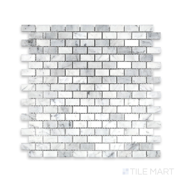 Tile arrangement of White Carrara Marble 5/8x1-1/4 brick honed mosaic showing soft-textured rectangular marble pieces in a clean brick layout