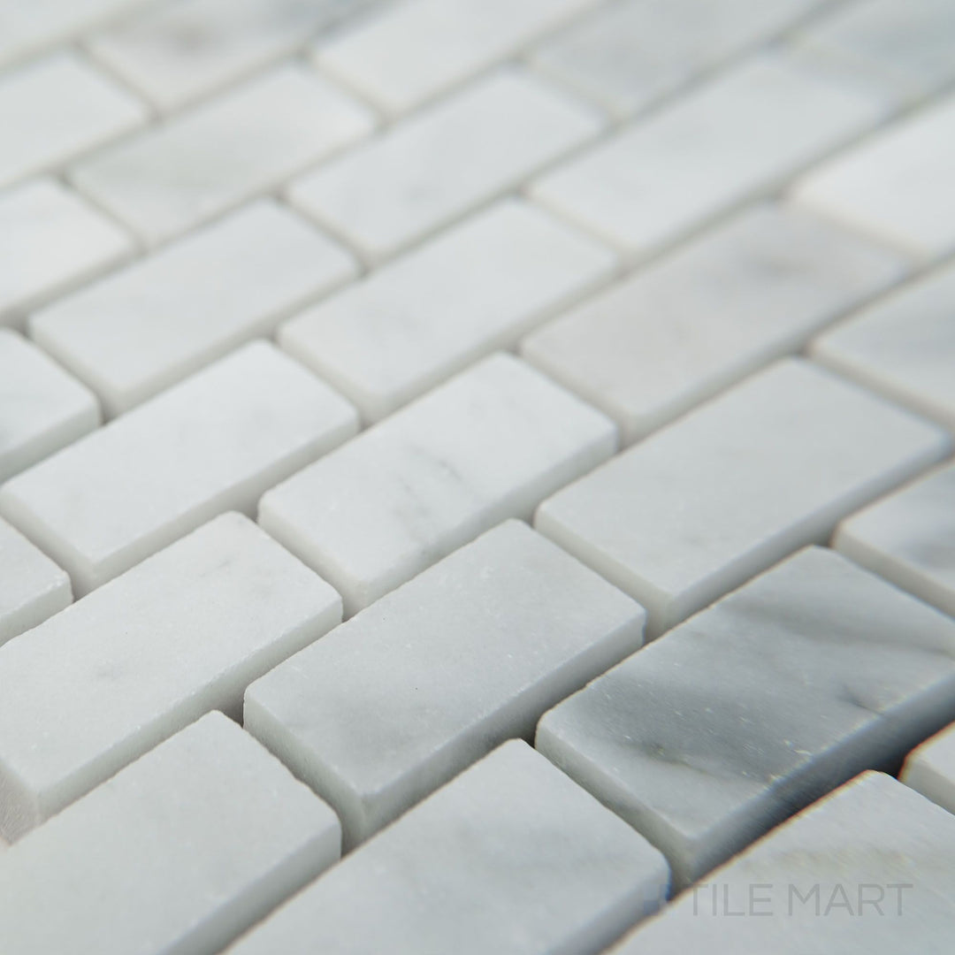 Corner view of White Carrara Marble 5/8x1-1/4 brick honed mosaic showcasing soft matte marble bricks arranged in a classic pattern