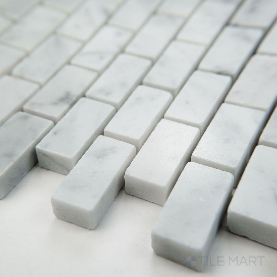 Tile corner display of White Carrara Marble 5/8x1-1/4 brick polished mosaic featuring glossy marble bricks in a clean structured layout