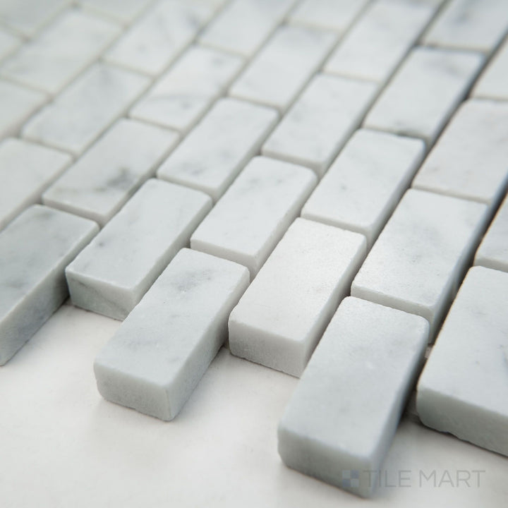 Tile corner display of White Carrara Marble 5/8x1-1/4 brick polished mosaic featuring glossy marble bricks in a clean structured layout