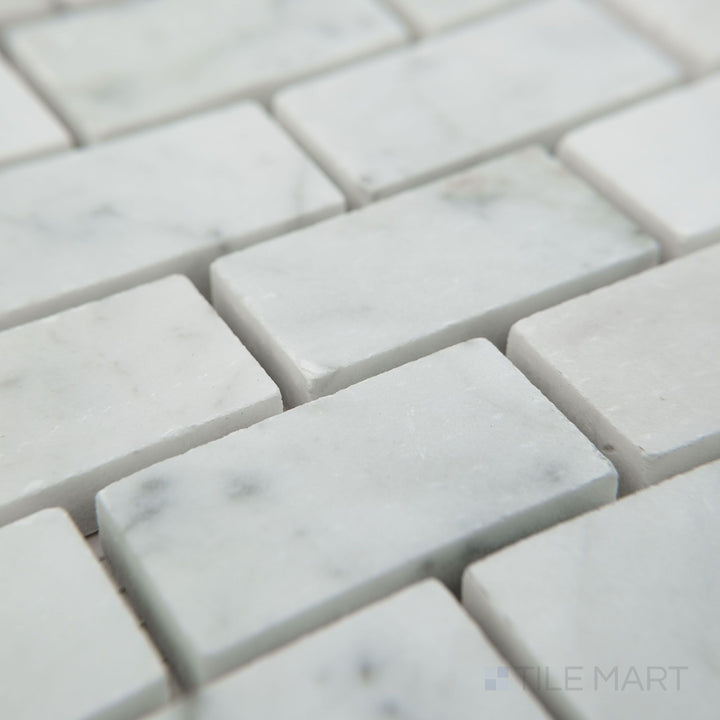Tile shown from corner angle of White Carrara Marble 1x2 brick honed mosaic revealing soft-finish marble rectangles arranged neatly