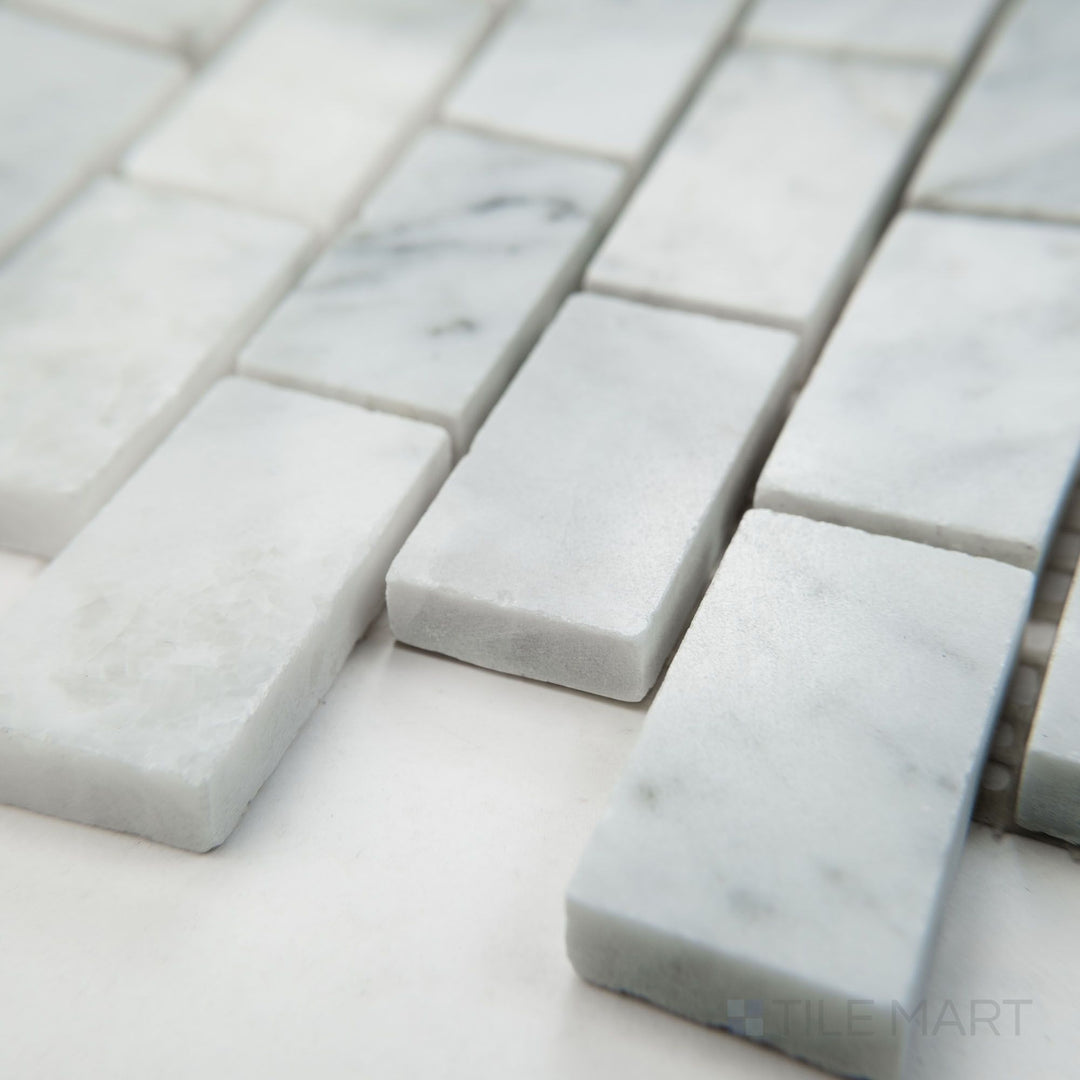 Corner view of White Carrara Marble 1x2 brick polished mosaic showcasing bright glossy marble bricks laid in a traditional pattern