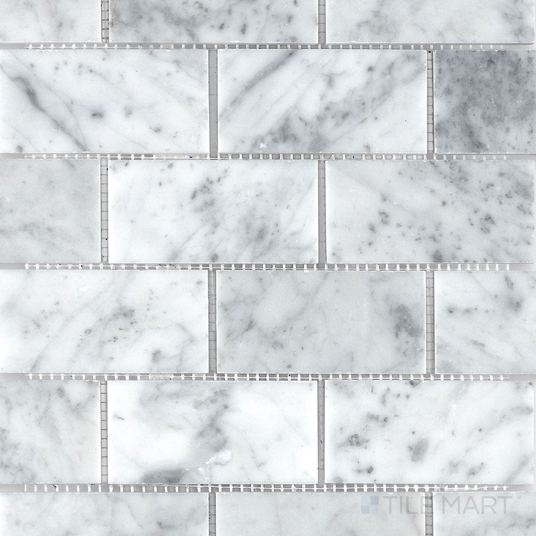 Top view of White Carrara Marble 2x4 brick honed mosaic tiles, offering a soft textured surface with a traditional subway tile look