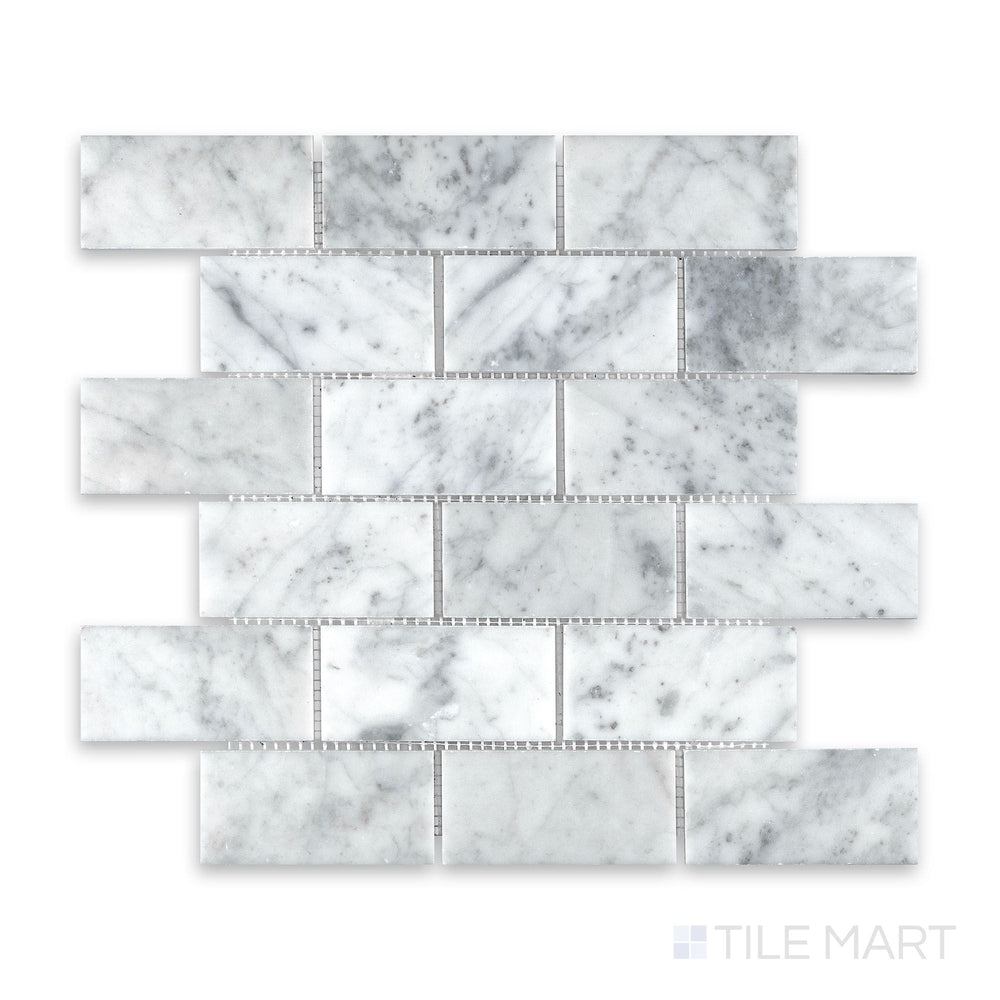 Mosaic display of White Carrara Marble 2x4 brick honed mosaic showing large soft-finish marble tiles in a traditional running bond arrangement