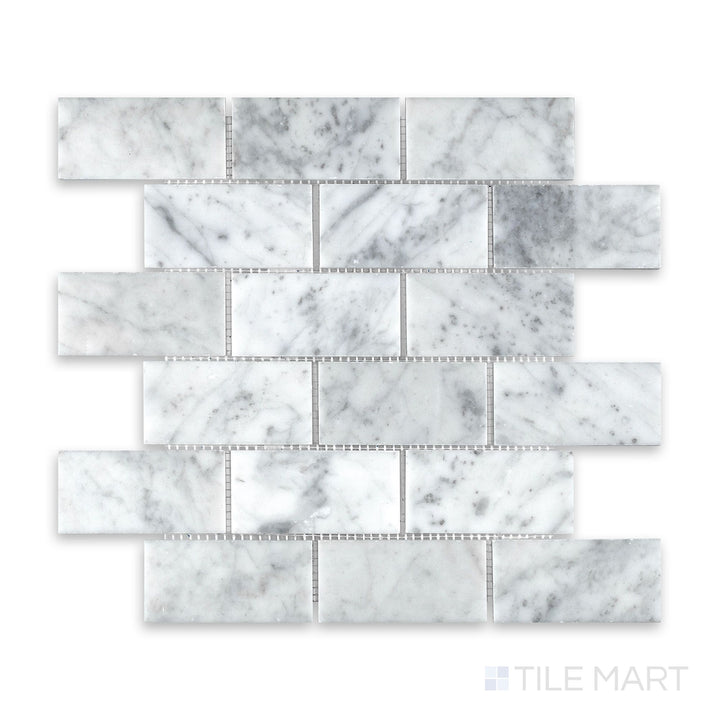 Mosaic display of White Carrara Marble 2x4 brick honed mosaic showing large soft-finish marble tiles in a traditional running bond arrangement