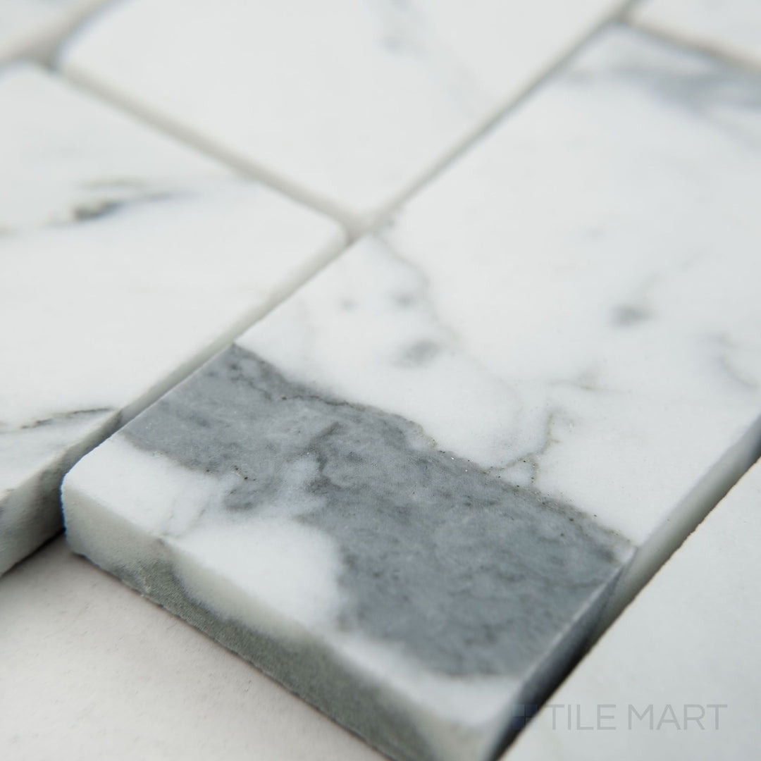 Corner view of White Carrara Marble 2x4 brick honed mosaic featuring matte marble bricks arranged in a clean rectangular pattern