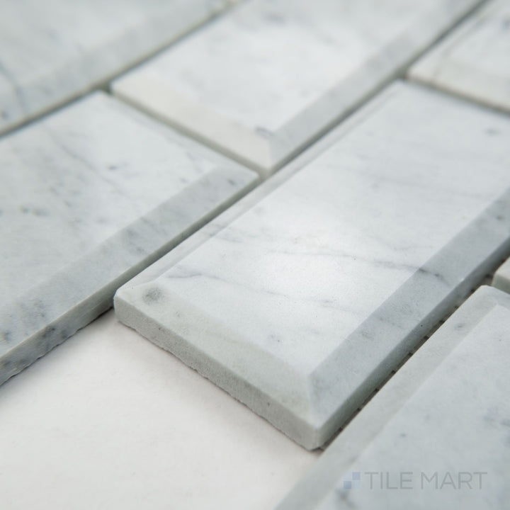 Tile corner display of White Carrara Marble 2x4 brick beveled polished mosaic highlighting glossy beveled marble bricks