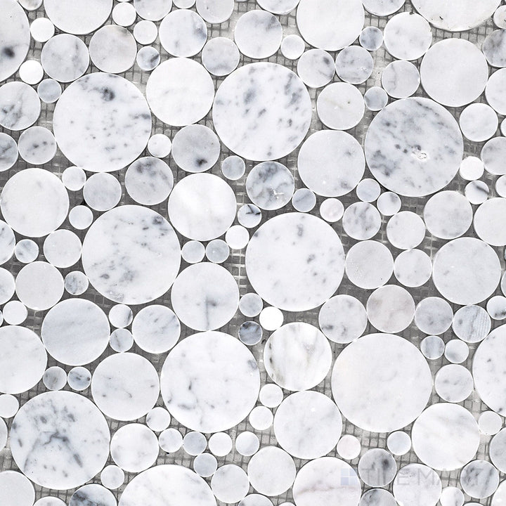Flat lay of White Carrara Marble bubble honed mosaic tile, showing small circular marble pieces with a soft textured finish for playful surfaces