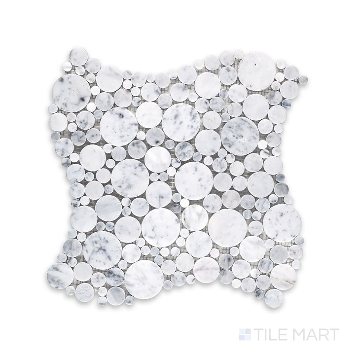 Mosaic display of White Carrara Marble bubble honed mosaic featuring small matte marble circles arranged in a playful, organic layout