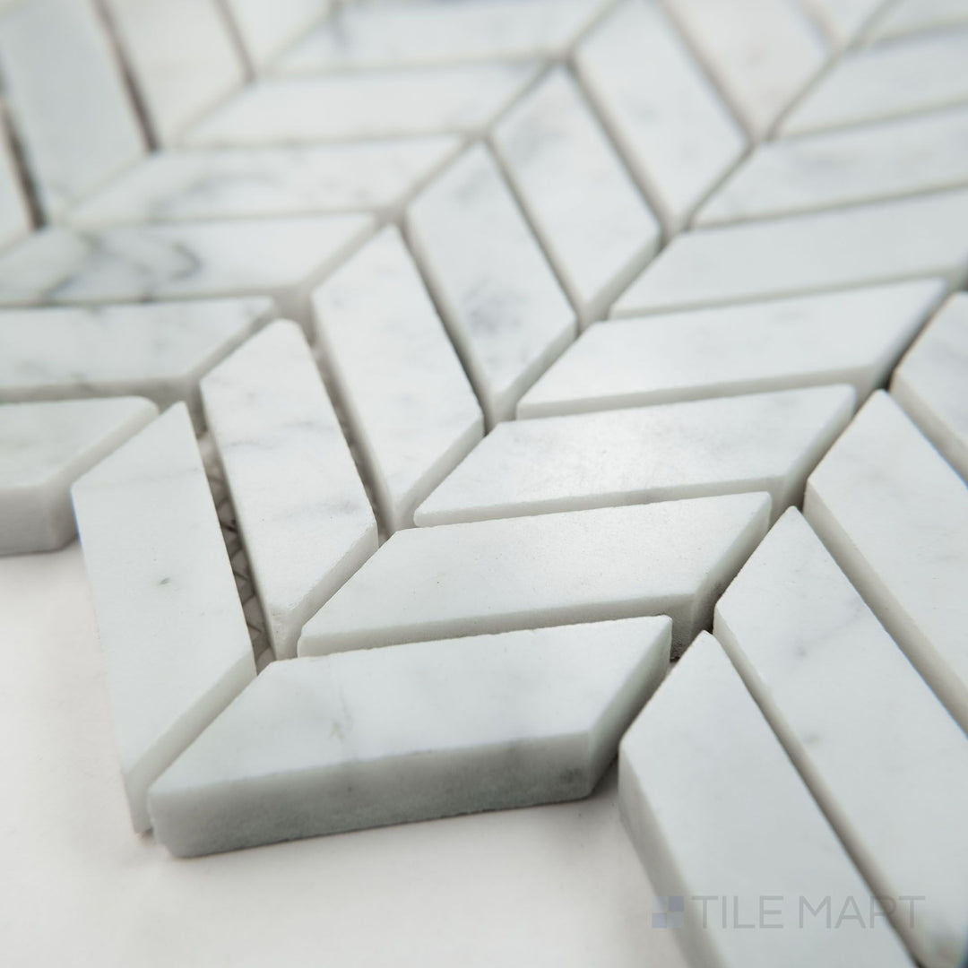 Angled view of White Carrara Marble mini chevron polished mosaic showcasing tiny glossy marble chevrons arranged in a sharp V-pattern