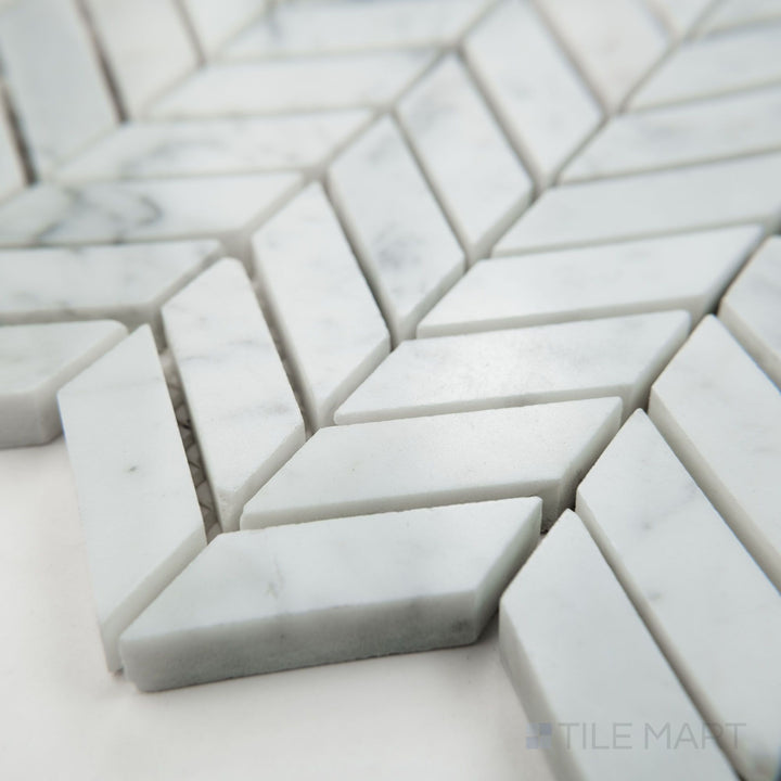 Angled view of White Carrara Marble mini chevron polished mosaic showcasing tiny glossy marble chevrons arranged in a sharp V-pattern
