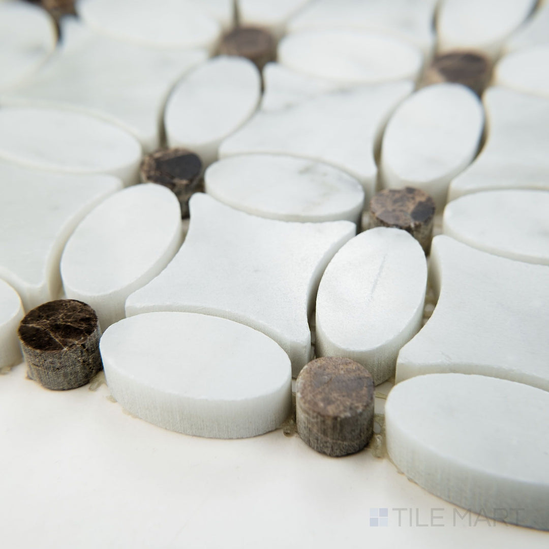 Angled shot of White Carrara Marble flower mosaic with Emperador Dark in polished finish, featuring striking veining and a reflective, high-end marble look.