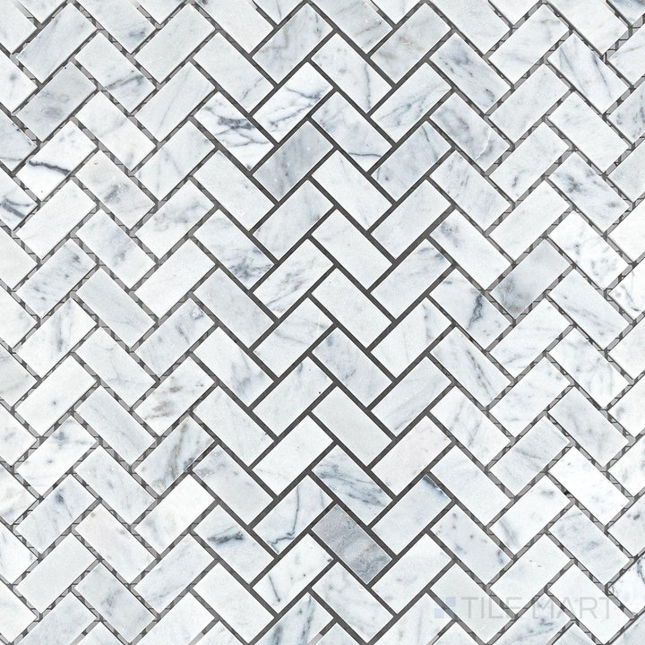 Overhead shot showing White Carrara Marble 5/8x1-1/4 herringbone honed mosaic, highlighting a traditional angled design with a smooth textured finish