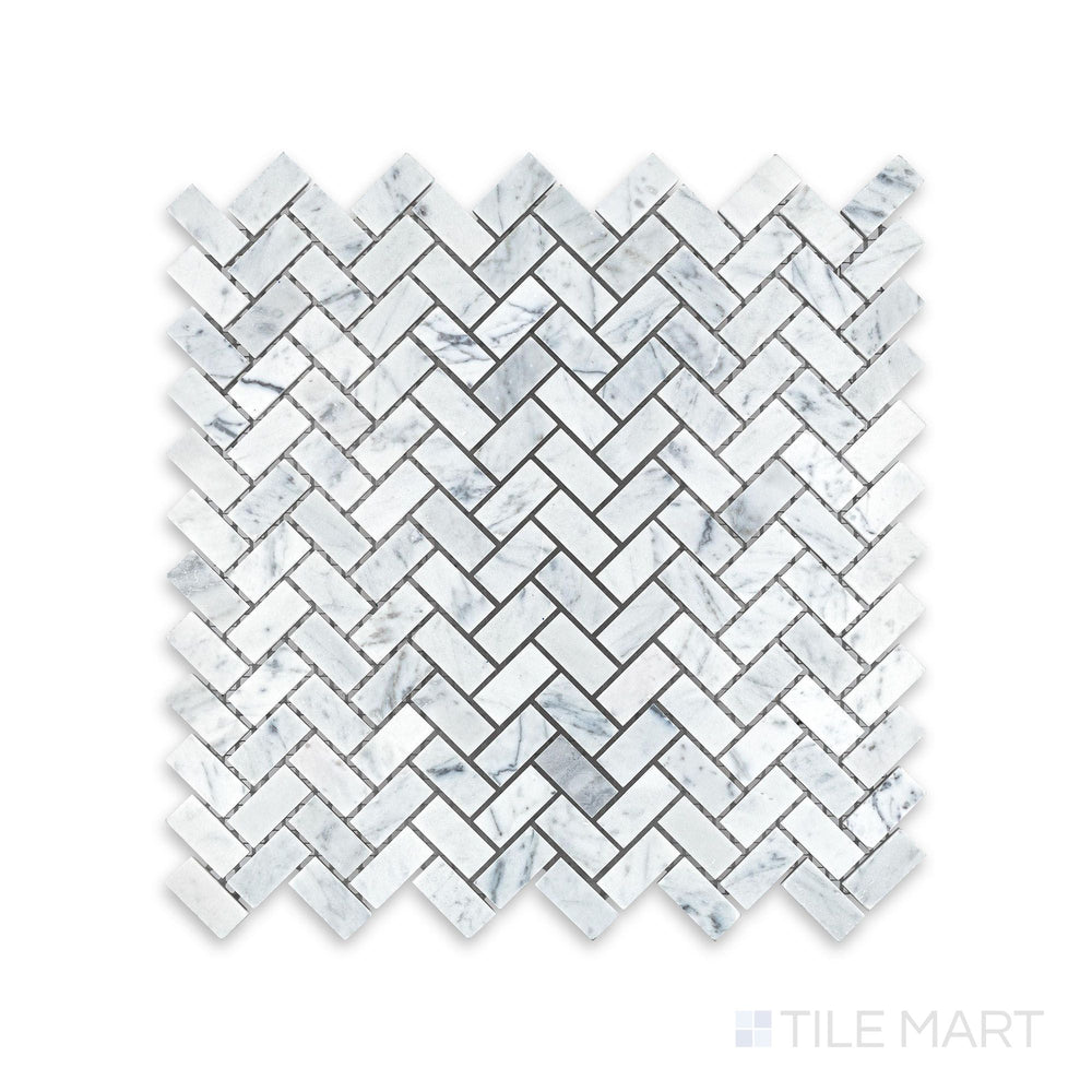 Tile showcase of White Carrara Marble 5/8x1-1/4 herringbone honed mosaic highlighting soft-textured marble tiles forming a dynamic V-shaped design