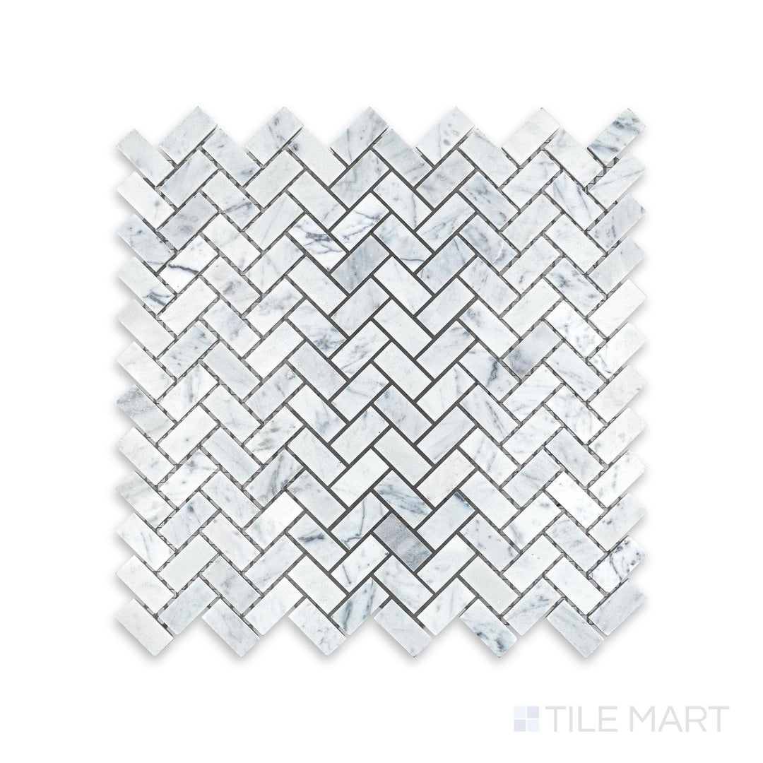 Tile showcase of White Carrara Marble 5/8x1-1/4 herringbone honed mosaic highlighting soft-textured marble tiles forming a dynamic V-shaped design