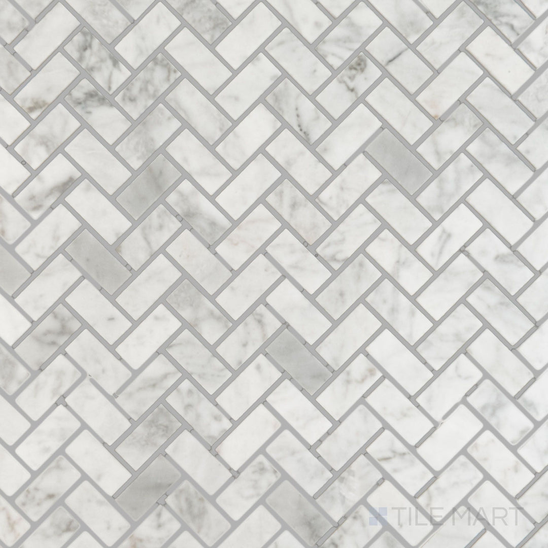 Flat overhead image of White Carrara Marble 5/8x1-1/4 herringbone polished mosaic, featuring glossy marble pieces arranged in a dynamic V-shaped pattern