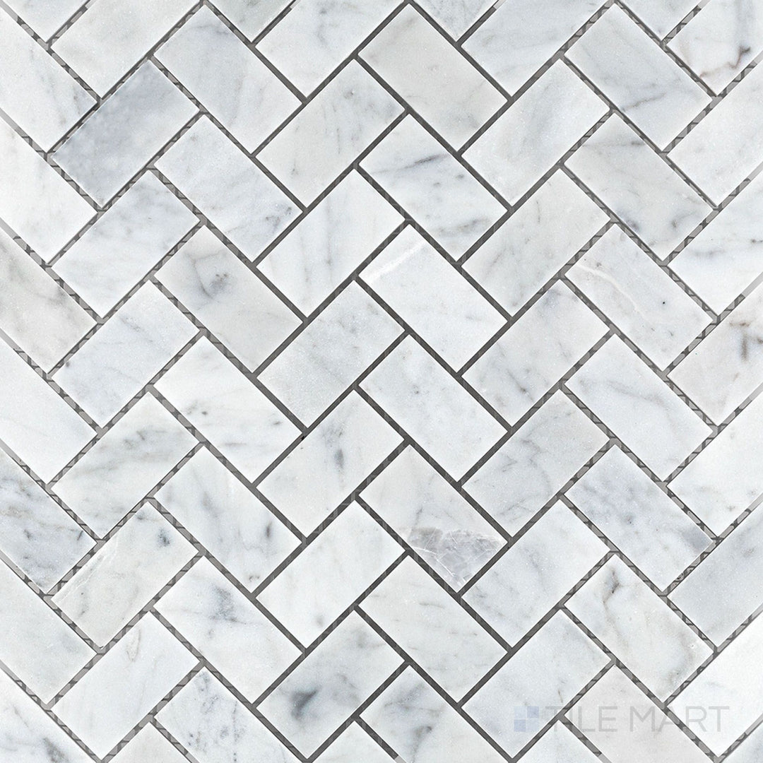 Top-down image of White Carrara Marble 1x2 herringbone honed mosaic, featuring sleek elongated tiles arranged in a soft matte V-pattern