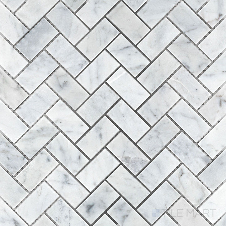 Top-down image of White Carrara Marble 1x2 herringbone honed mosaic, featuring sleek elongated tiles arranged in a soft matte V-pattern