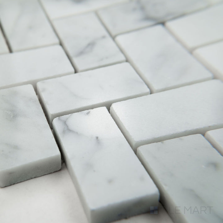 Corner view of White Carrara Marble 1x2 herringbone polished mosaic featuring sleek glossy marble tiles in a V-shaped layout