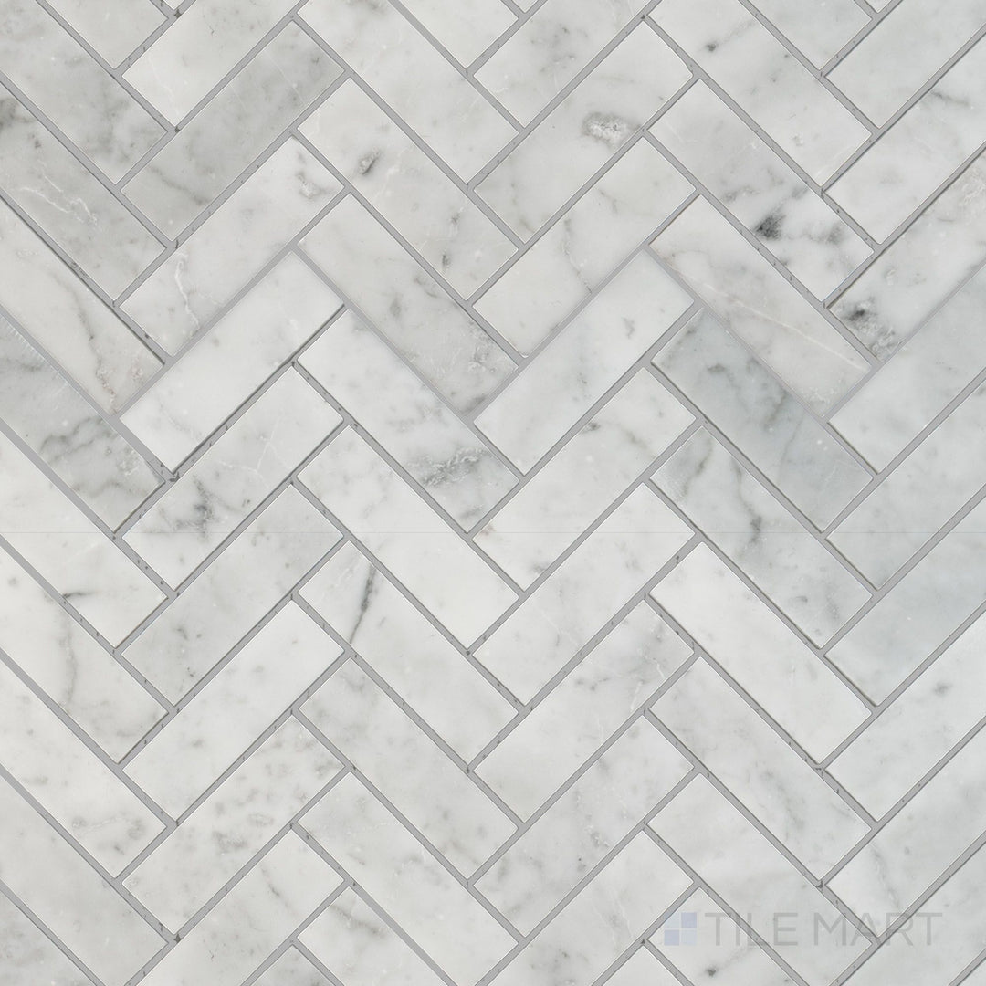 Top-down view of White Carrara Marble 1x3 herringbone honed mosaic featuring soft matte marble tiles arranged in a classic V-shaped pattern