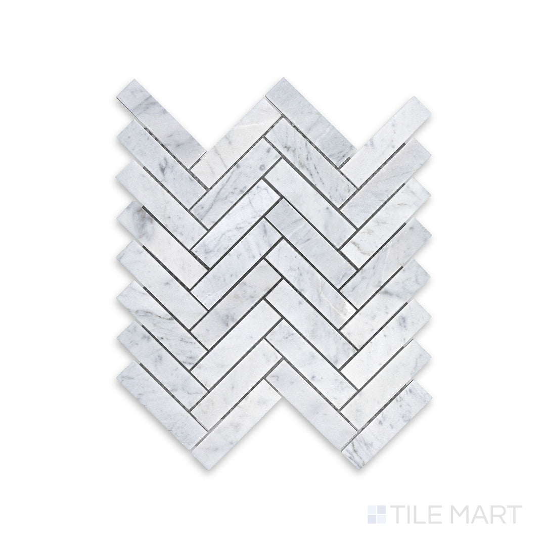 Mosaic display of White Carrara Marble 1x4 herringbone honed mosaic showing elongated matte marble tiles arranged in a dynamic zigzag pattern