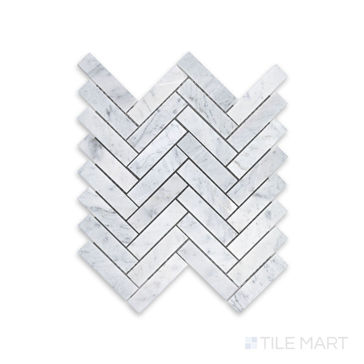 Mosaic display of White Carrara Marble 1x4 herringbone honed mosaic showing elongated matte marble tiles arranged in a dynamic zigzag pattern
