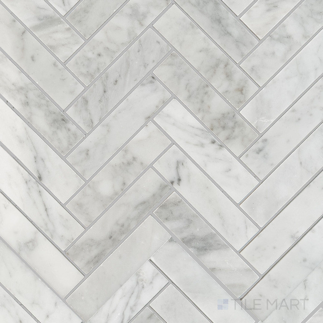 Overhead shot of White Carrara Marble 1x4 herringbone polished mosaic featuring polished marble strips laid in a classic, elegant herringbone pattern