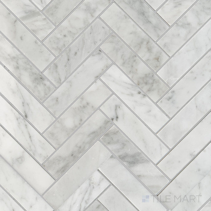 Overhead shot of White Carrara Marble 1x4 herringbone polished mosaic featuring polished marble strips laid in a classic, elegant herringbone pattern